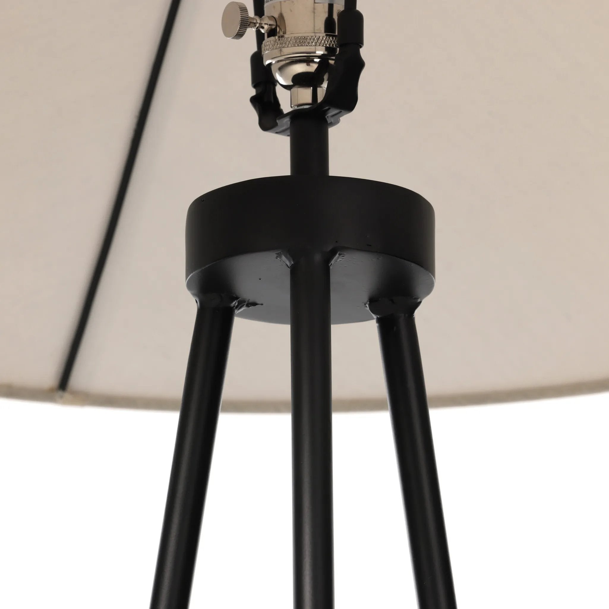 An exaggeratedly slim, airy tripod base of black-finished iron supports a light beige shade of 100% cotton, for a classic look with contrast Amethyst Home provides interior design, new home construction design consulting, vintage area rugs, and lighting in the Tampa metro area.