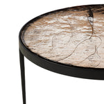 Smoky brown glass-topped table with slim, tapered matte black metal frames for a sleek, modern look. Part of a nesting set, can be used alone or paired with its smaller counterpart.Collection: Marlo Amethyst Home provides interior design, new home construction design consulting, vintage area rugs, and lighting in the Houston metro area.