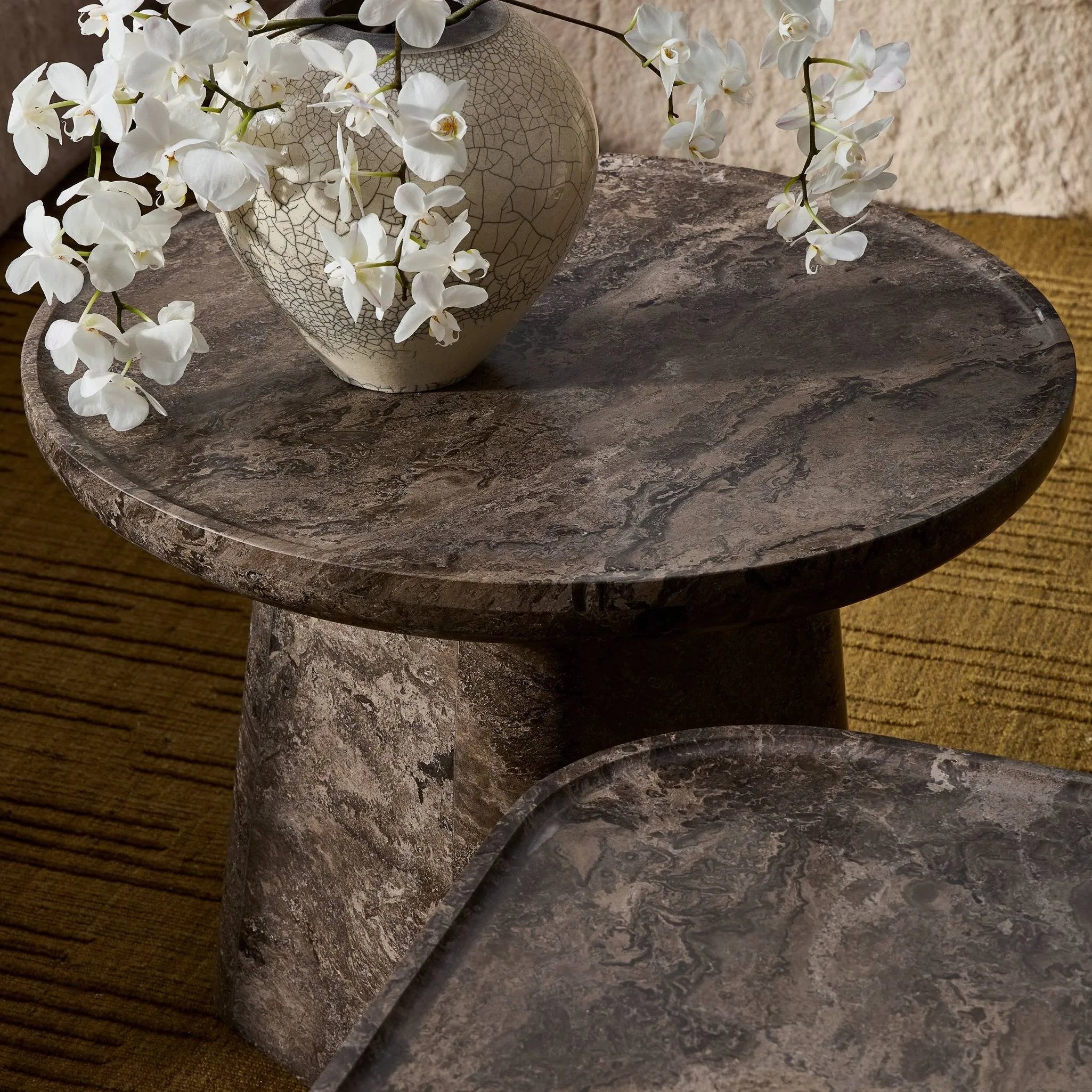 Featuring Zane Warm Grey Marble End Table by Four Hands at Amethyst Home. Ground your living space with a rounded end table of grey-finished marble. With thoughtful design touches like bullnose edging and a tray-style top, this table's detailing crafts an elevated artisan look that's sure to spark conversation. Overall Dimensions: 24.50"w x 24.50"d x 18.00". Amethyst Home provides interior design, new home construction design consulting, vintage area rugs, and lighting in the Charlotte metro area.