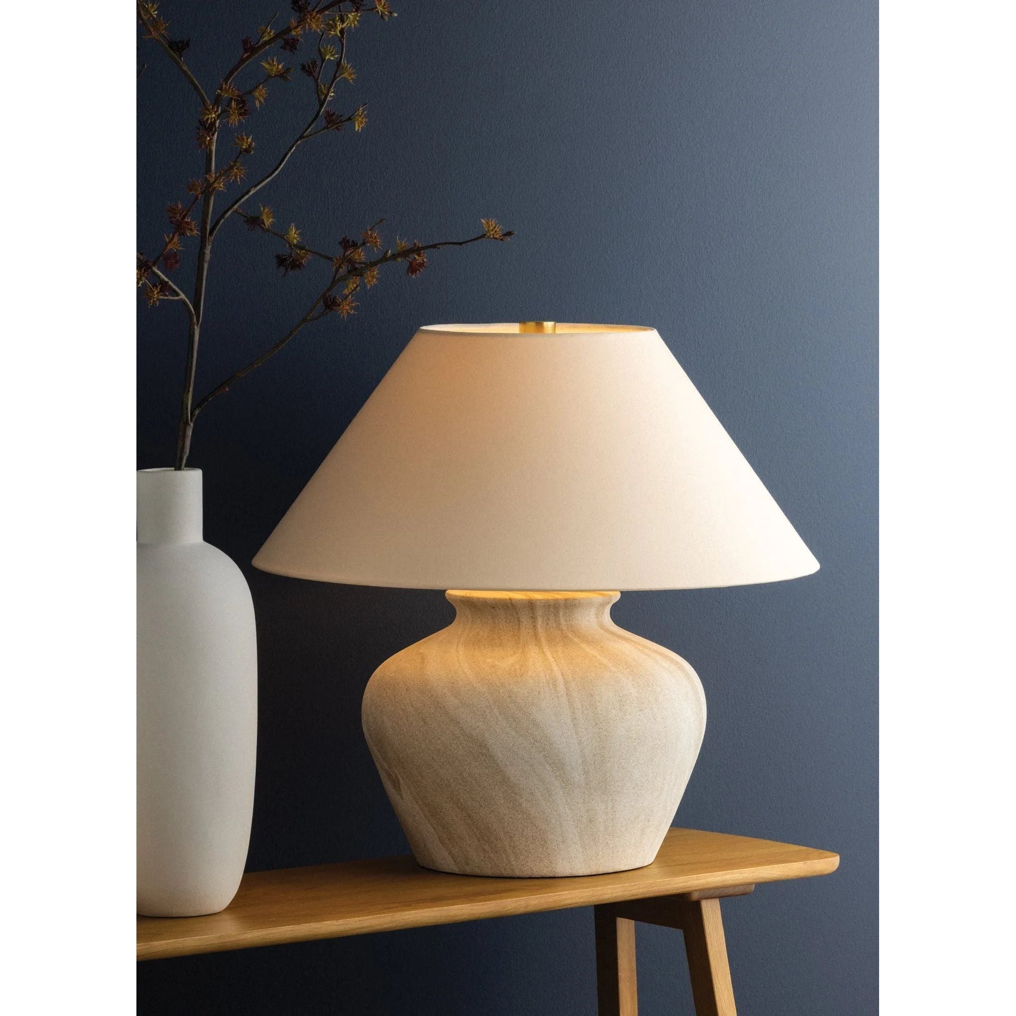 The Allards table lamp draws inspiration from traditional pottery and the beauty of artisan glazing. Its ceramic, urn-like silhouette is finished in Watercolor Sand with a painterly application that lends movement to the surface. Amethyst Home provides interior design, new home construction design consulting, vintage area rugs, and lighting in the Miami metro area.