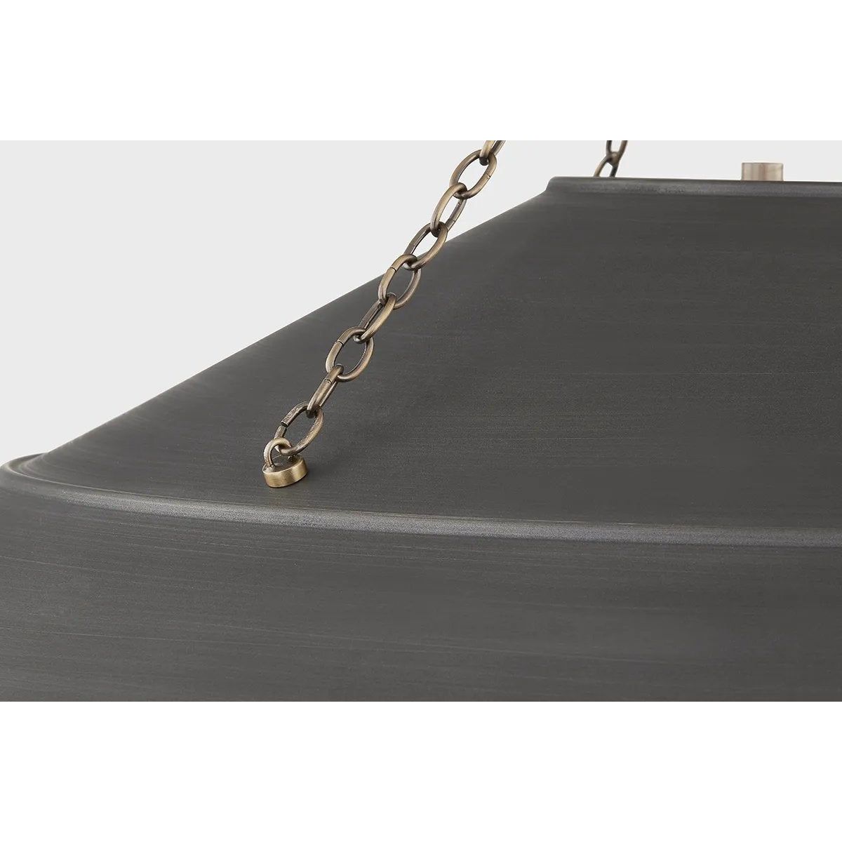 With its exposed metalwork, chain detailing, and unique finish combination, Arcane has an elevated, industrial vibe. The graphite shade feels chic and gives off a warm glow. The Patina Brass hardware, chain, and canopy add a hint of shine that plays wonderfully off the graphite. Amethyst Home provides interior design, new home construction design consulting, vintage area rugs, and lighting in the Boston metro area.