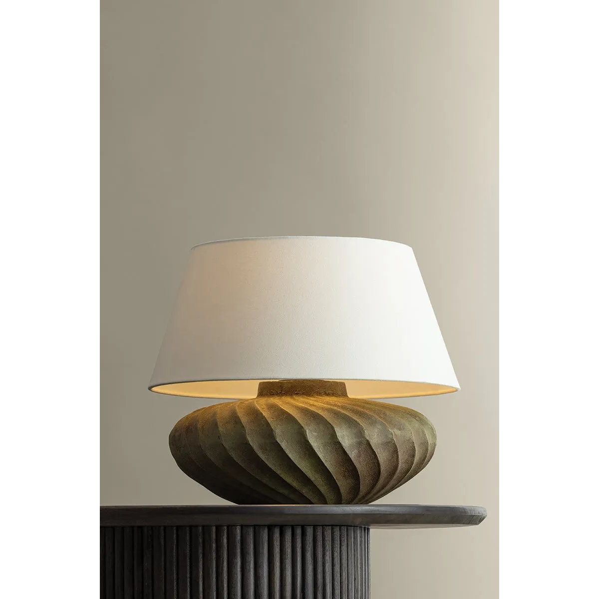 The Arlin family of table lamps pairs sculptural form with rich texture. Patterned metal bases feature a swirling motif that wraps each vessel shape, offered in two silhouettes: a fuller, more rounded form in Black Patina and a taller, generous form in Bronze Patina. Amethyst Home provides interior design, new home construction design consulting, vintage area rugs, and lighting in the Houston metro area.