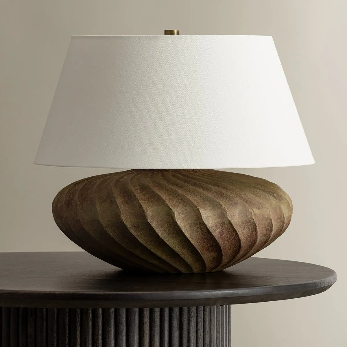 The Arlin family of table lamps pairs sculptural form with rich texture. Patterned metal bases feature a swirling motif that wraps each vessel shape, offered in two silhouettes: a fuller, more rounded form in Black Patina and a taller, generous form in Bronze Patina. Amethyst Home provides interior design, new home construction design consulting, vintage area rugs, and lighting in the San Diego metro area.