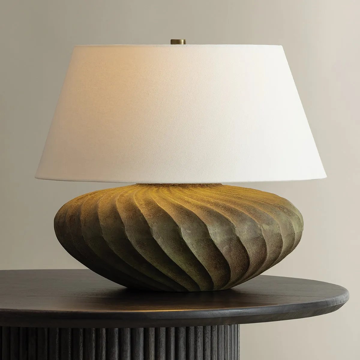 The Arlin family of table lamps pairs sculptural form with rich texture. Patterned metal bases feature a swirling motif that wraps each vessel shape, offered in two silhouettes: a fuller, more rounded form in Black Patina and a taller, generous form in Bronze Patina. Amethyst Home provides interior design, new home construction design consulting, vintage area rugs, and lighting in the Tampa metro area.