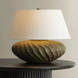 The Arlin family of table lamps pairs sculptural form with rich texture. Patterned metal bases feature a swirling motif that wraps each vessel shape, offered in two silhouettes: a fuller, more rounded form in Black Patina and a taller, generous form in Bronze Patina. Amethyst Home provides interior design, new home construction design consulting, vintage area rugs, and lighting in the Tampa metro area.