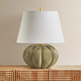The Beata table lamp makes a sculptural, yet playful statement. A rounded ceramic base, finished in a Harbor Gray Crackle glaze, recalls the shape of a pumpkin. The elongated white linen shade balances the voluminous form, while Aged Brass hardware at the neck adds a polished note. Amethyst Home provides interior design, new home construction design consulting, vintage area rugs, and lighting in the San Diego metro area.