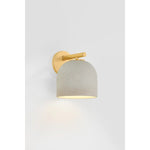 Inspired by Neoclassical architecture, Cara uses a domed shade and textural ceramic finish for a sconce that feels both ancient and new. A matte reactive glaze in an creamy hue creates a subtle surface grain that imitates natural stone. A circular modern armback in an Aged Brass finish adds shine to the fixture.  Amethyst Home provides interior design, new home construction design consulting, vintage area rugs, and lighting in the Los Angeles metro area.