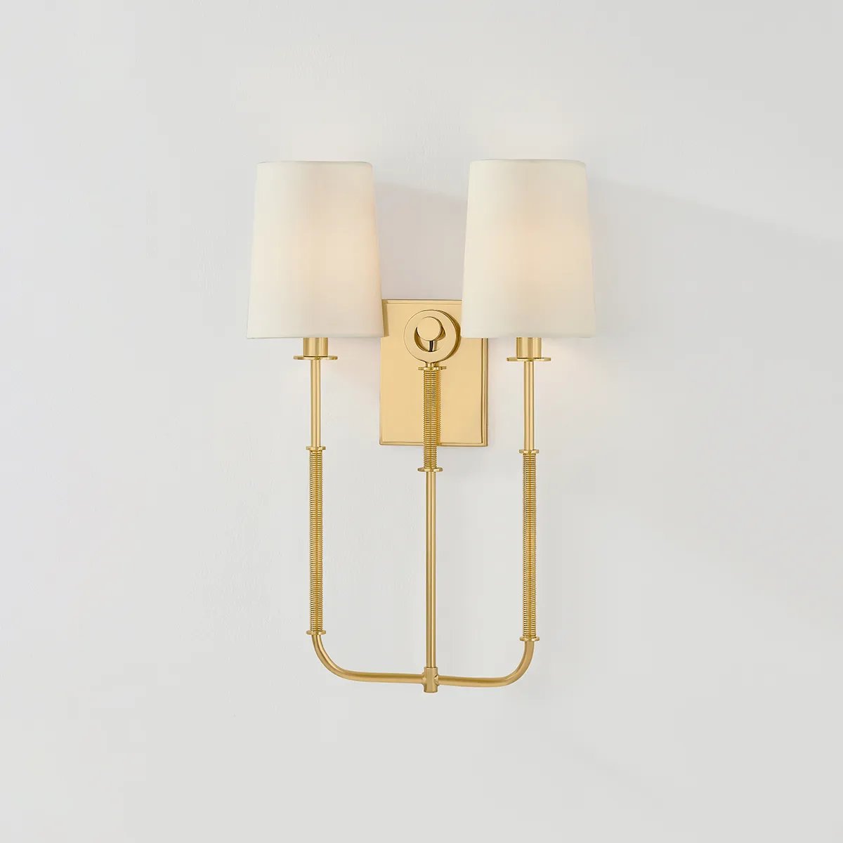 The antique-inspired silhouette of the Glenmont sconce is slender and refined with machine-led hardware. Each stem features a horizontal knurl resembling a screw, adding texture and a contemporary feel to the fixture. Amethyst Home provides interior design, new home construction design consulting, vintage area rugs, and lighting in the Winter Garden metro area.