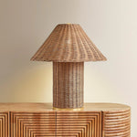 Woven from natural wicker, the Jeanette table lamp channels the inviting spirit of cottagecore with a bold, sculptural silhouette. A textural shade rests on a matching body, with a rim of decorative Aged Brass glimmering at the base. Perfect for a console, end table, or bedside, Jeanette infuses any space with a dose of charm Amethyst Home provides interior design, new home construction design consulting, vintage area rugs, and lighting in the Kansas City metro area.