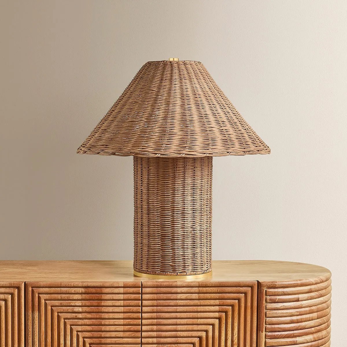 Woven from natural wicker, the Jeanette table lamp channels the inviting spirit of cottagecore with a bold, sculptural silhouette. A textural shade rests on a matching body, with a rim of decorative Aged Brass glimmering at the base. Perfect for a console, end table, or bedside, Jeanette infuses any space with a dose of charm Amethyst Home provides interior design, new home construction design consulting, vintage area rugs, and lighting in the Newport Beach metro area.