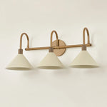 A modern interpretation of Art Deco shapes, the Jovani bath bar features elongated arms and sharply tapered Soft Sand shades. The clean design highlights the connections between elements through pronounced fittings and subtle fluting details. Finished in classic Patina Brass, Jovani is available with 1, 2, or 3 lights. Amethyst Home provides interior design, new home construction design consulting, vintage area rugs, and lighting in the Charlotte metro area.