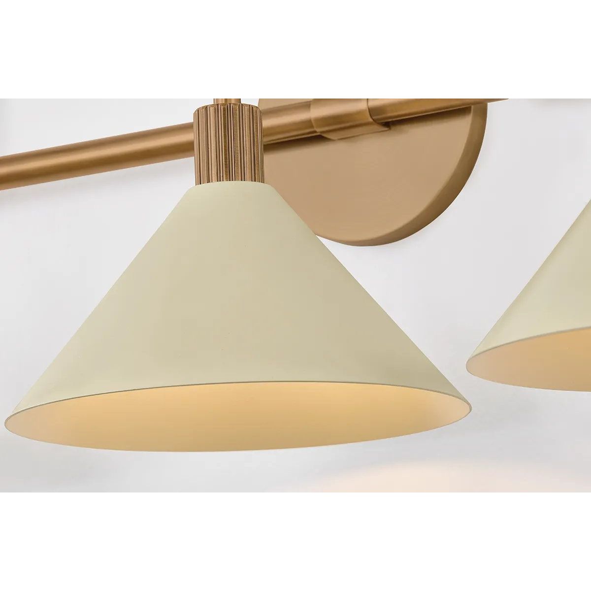 A modern interpretation of Art Deco shapes, the Jovani bath bar features elongated arms and sharply tapered Soft Sand shades. The clean design highlights the connections between elements through pronounced fittings and subtle fluting details. Finished in classic Patina Brass, Jovani is available with 1, 2, or 3 lights. Amethyst Home provides interior design, new home construction design consulting, vintage area rugs, and lighting in the Nashville metro area.