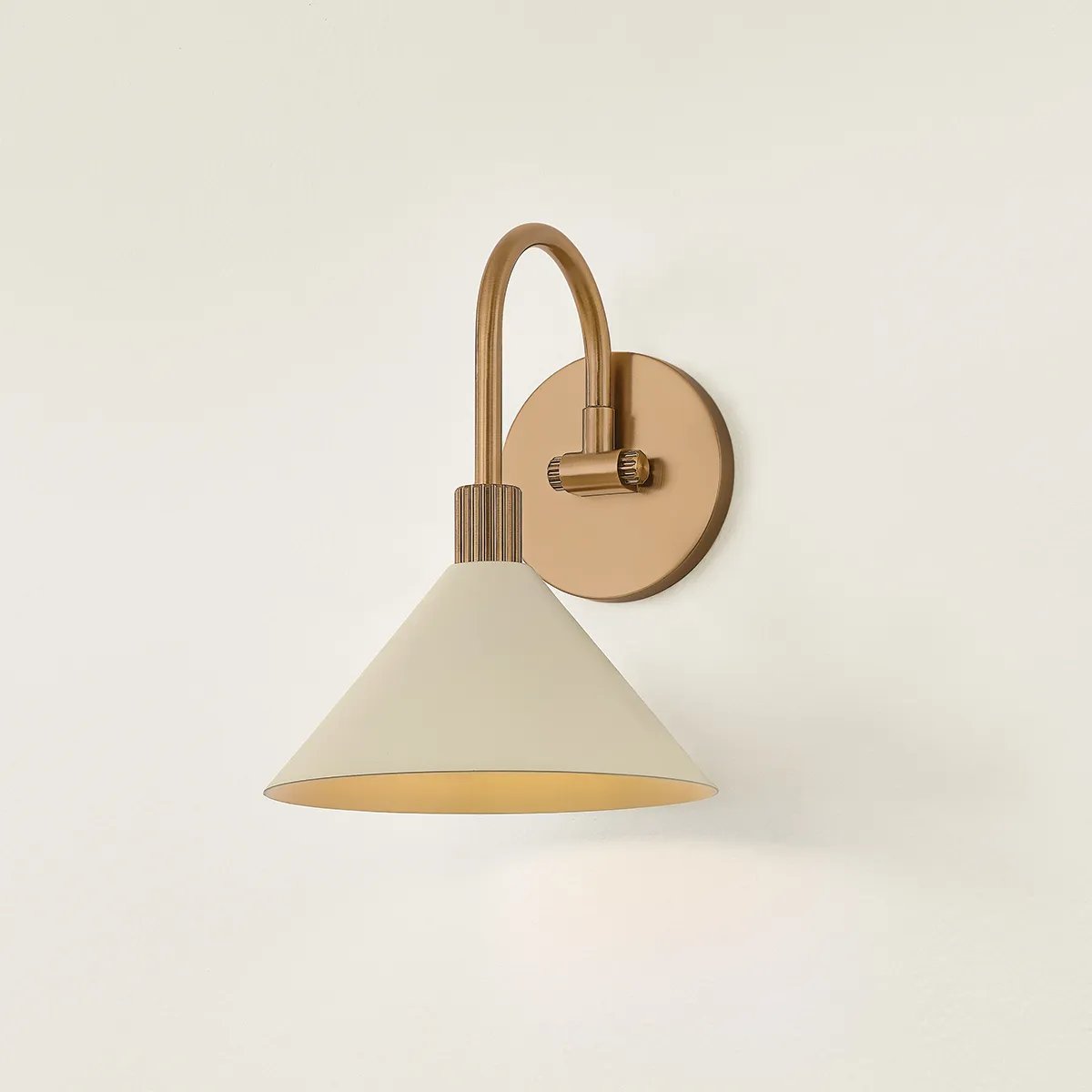 A modern interpretation of Art Deco shapes, the Jovani bath bar features elongated arms and sharply tapered Soft Sand shades. The clean design highlights the connections between elements through pronounced fittings and subtle fluting details. Finished in classic Patina Brass, Jovani is available with 1, 2, or 3 lights. Amethyst Home provides interior design, new home construction design consulting, vintage area rugs, and lighting in the Omaha metro area.