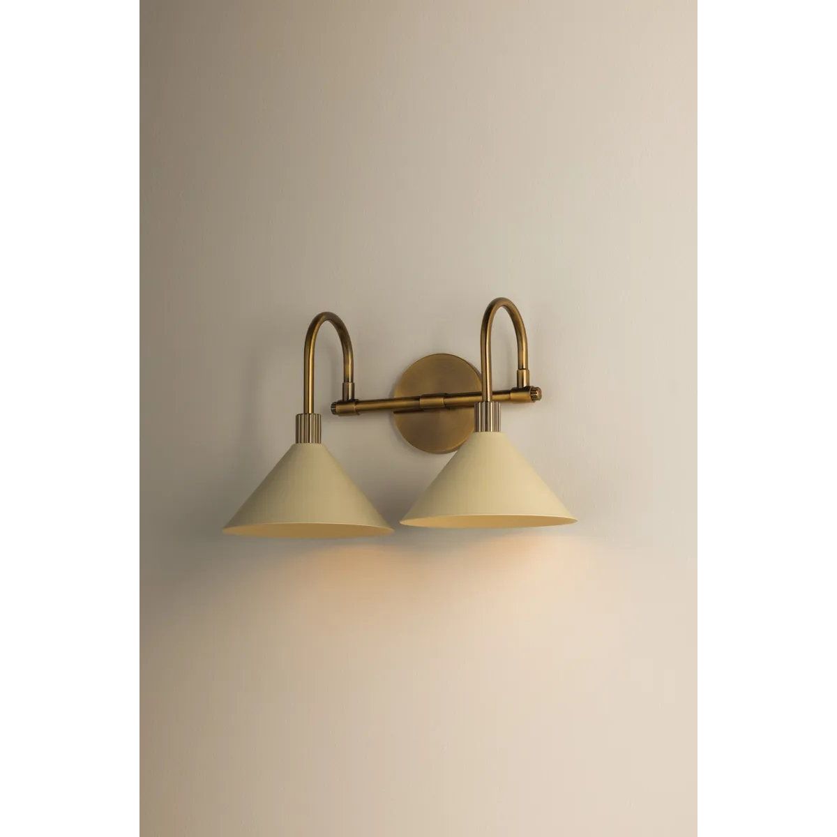 A modern interpretation of Art Deco shapes, the Jovani bath bar features elongated arms and sharply tapered Soft Sand shades. The clean design highlights the connections between elements through pronounced fittings and subtle fluting details. Finished in classic Patina Brass, Jovani is available with 1, 2, or 3 lights. Amethyst Home provides interior design, new home construction design consulting, vintage area rugs, and lighting in the Winter Garden metro area.