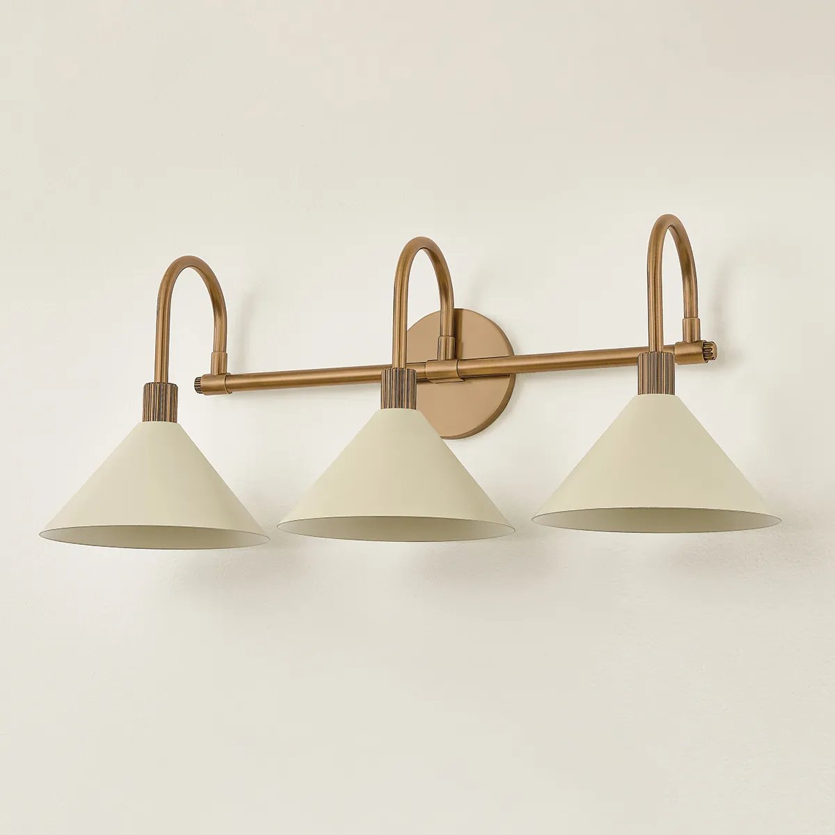 A modern interpretation of Art Deco shapes, the Jovani bath bar features elongated arms and sharply tapered Soft Sand shades. The clean design highlights the connections between elements through pronounced fittings and subtle fluting details. Finished in classic Patina Brass, Jovani is available with 1, 2, or 3 lights. Amethyst Home provides interior design, new home construction design consulting, vintage area rugs, and lighting in the Winter Garden metro area.