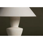 A series of three stacked, bowl-like shapes in ivory texture ceramic give this table lamp an organic, hand-crafted silhouette. The tapered off-white linen shade and Patina Brass accents add to the warm, natural beauty. Amethyst Home provides interior design, new home construction design consulting, vintage area rugs, and lighting in the Houston metro area.