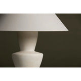 A series of three stacked, bowl-like shapes in ivory texture ceramic give this table lamp an organic, hand-crafted silhouette. The tapered off-white linen shade and Patina Brass accents add to the warm, natural beauty. Amethyst Home provides interior design, new home construction design consulting, vintage area rugs, and lighting in the Houston metro area.