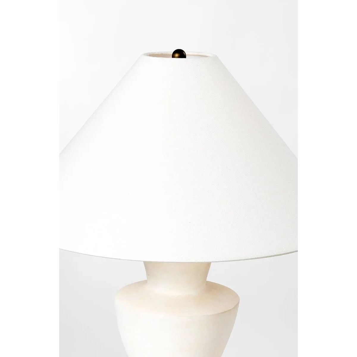 A series of three stacked, bowl-like shapes in ivory texture ceramic give this table lamp an organic, hand-crafted silhouette. The tapered off-white linen shade and Patina Brass accents add to the warm, natural beauty. Amethyst Home provides interior design, new home construction design consulting, vintage area rugs, and lighting in the Park City metro area.