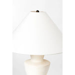A series of three stacked, bowl-like shapes in ivory texture ceramic give this table lamp an organic, hand-crafted silhouette. The tapered off-white linen shade and Patina Brass accents add to the warm, natural beauty. Amethyst Home provides interior design, new home construction design consulting, vintage area rugs, and lighting in the Park City metro area.