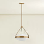 The Kade pendant updates a nostalgic shape with sleek, industrial metalwork and two large opal matte glass shades. Inspired by vintage elements, it features a striking suspension technique with three oversized loops connecting to the central housing above the fixture. The Patina Brass finish adds old-world finesse to the frame. Amethyst Home provides interior design, new home construction design consulting, vintage area rugs, and lighting in the Laguna Beach metro area.