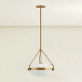 The Kade pendant updates a nostalgic shape with sleek, industrial metalwork and two large opal matte glass shades. Inspired by vintage elements, it features a striking suspension technique with three oversized loops connecting to the central housing above the fixture. The Patina Brass finish adds old-world finesse to the frame. Amethyst Home provides interior design, new home construction design consulting, vintage area rugs, and lighting in the Laguna Beach metro area.