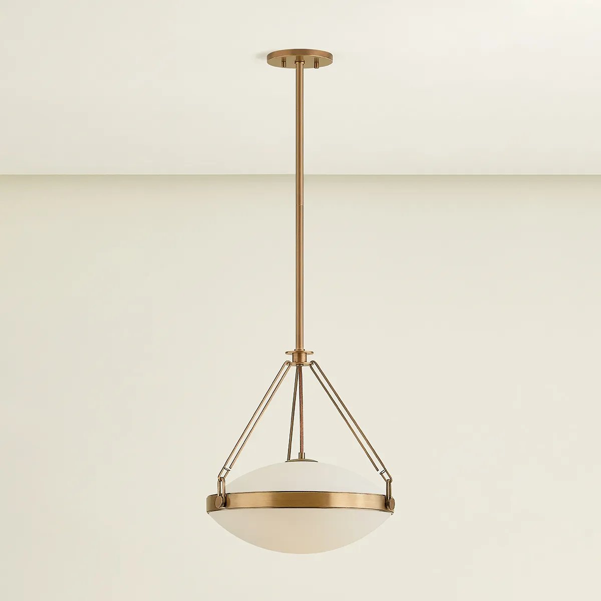 The Kade pendant updates a nostalgic shape with sleek, industrial metalwork and two large opal matte glass shades. Inspired by vintage elements, it features a striking suspension technique with three oversized loops connecting to the central housing above the fixture. The Patina Brass finish adds old-world finesse to the frame. Amethyst Home provides interior design, new home construction design consulting, vintage area rugs, and lighting in the Winter Garden metro area.