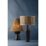 A unique approach to shading, clever play on proportions, and intriguing use of textures make the Mannsville table lamp a worthy conversation piece. Carved from Black Pine Wood, the tapered base gives the lamp a rich, organic aesthetic. Amethyst Home provides interior design, new home construction design consulting, vintage area rugs, and lighting in the Boston metro area.