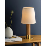 The Meadowbrook rechargeable lamp reinterprets a traditional silhouette with charming details. A beautifully grained light oak base rests upon a scalloped Aged Brass foot, introducing a graphic floral element. Topped with a classic white linen shade, the design balances decorative appeal with modern tailoring. Amethyst Home provides interior design, new home construction design consulting, vintage area rugs, and lighting in the Austin metro area.