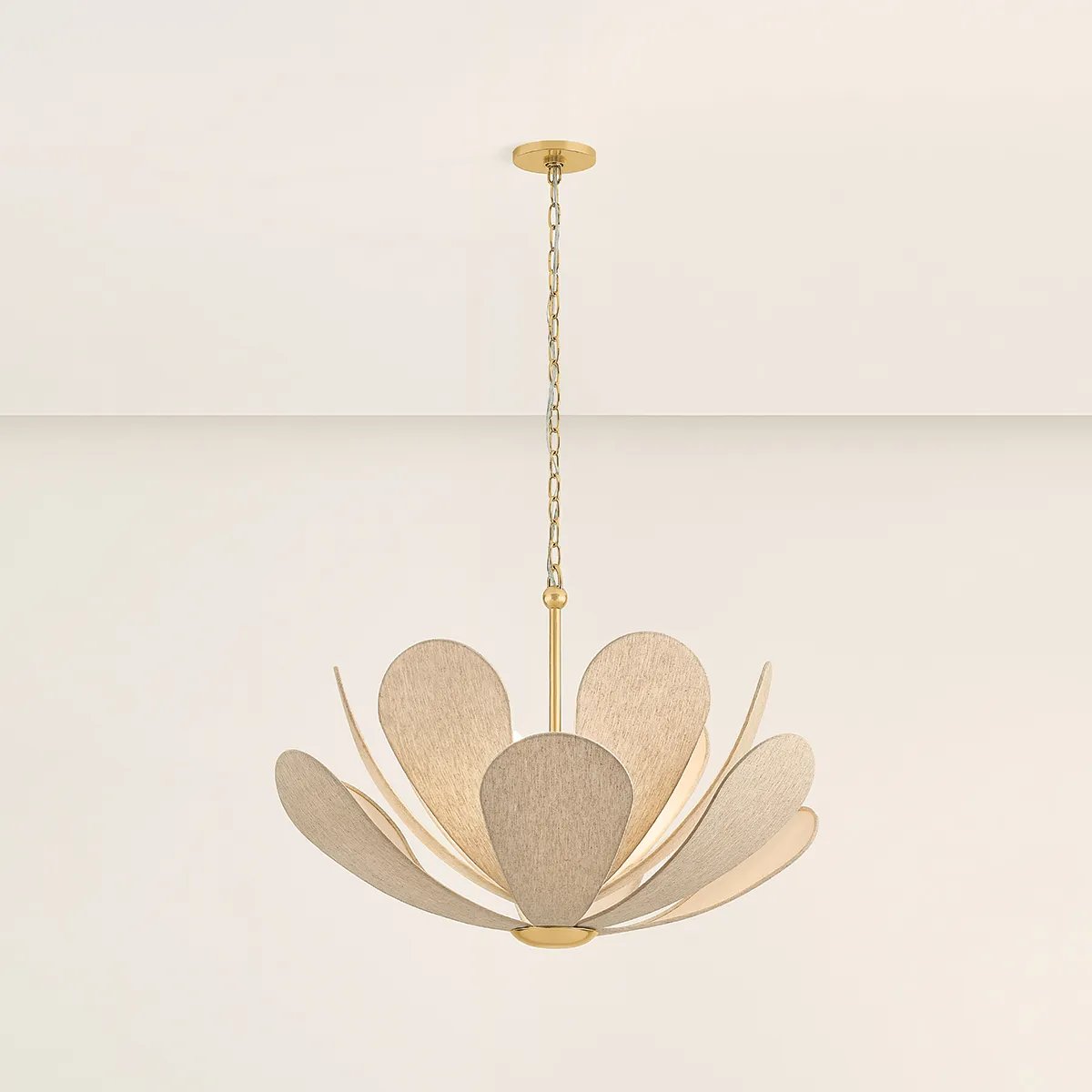Inspired by the softly layered petals of a coneflower, this whimsical pendant blooms in mid-air to create an airy centerpiece. The natural linen shades of Nadine curl into a staggered, domed array that conceals the inner light source. Elegantly suspended from a refined Aged Brass rod and chain, Nadine is a botanic delight for the modern home.  Amethyst Home provides interior design, new home construction design consulting, vintage area rugs, and lighting in the Boston metro area.
