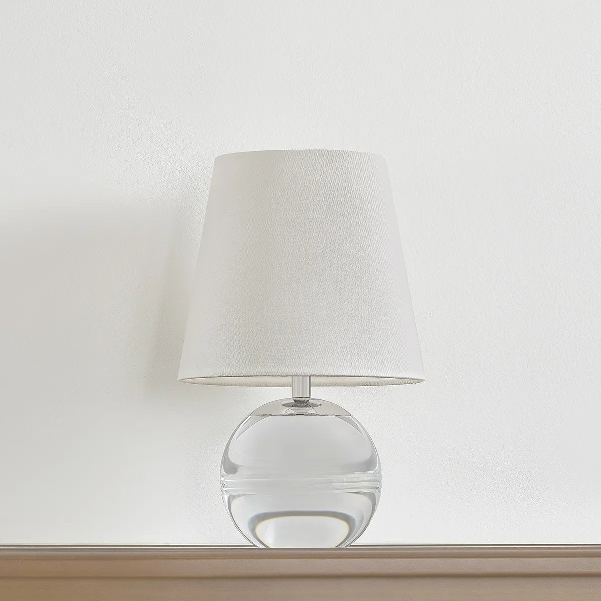 Ridged with ripple-like cuts, the crystal base of the Nicole table lamp makes for an eye-catching accent piece. Topped with a beautiful white linen shade, this pretty portable is rechargeable, adding convenience when styling. With classic Aged Brass-finished hardware, it’s the perfect addition to any bookshelf or small space. Amethyst Home provides interior design, new home construction design consulting, vintage area rugs, and lighting in the Los Angeles metro area.