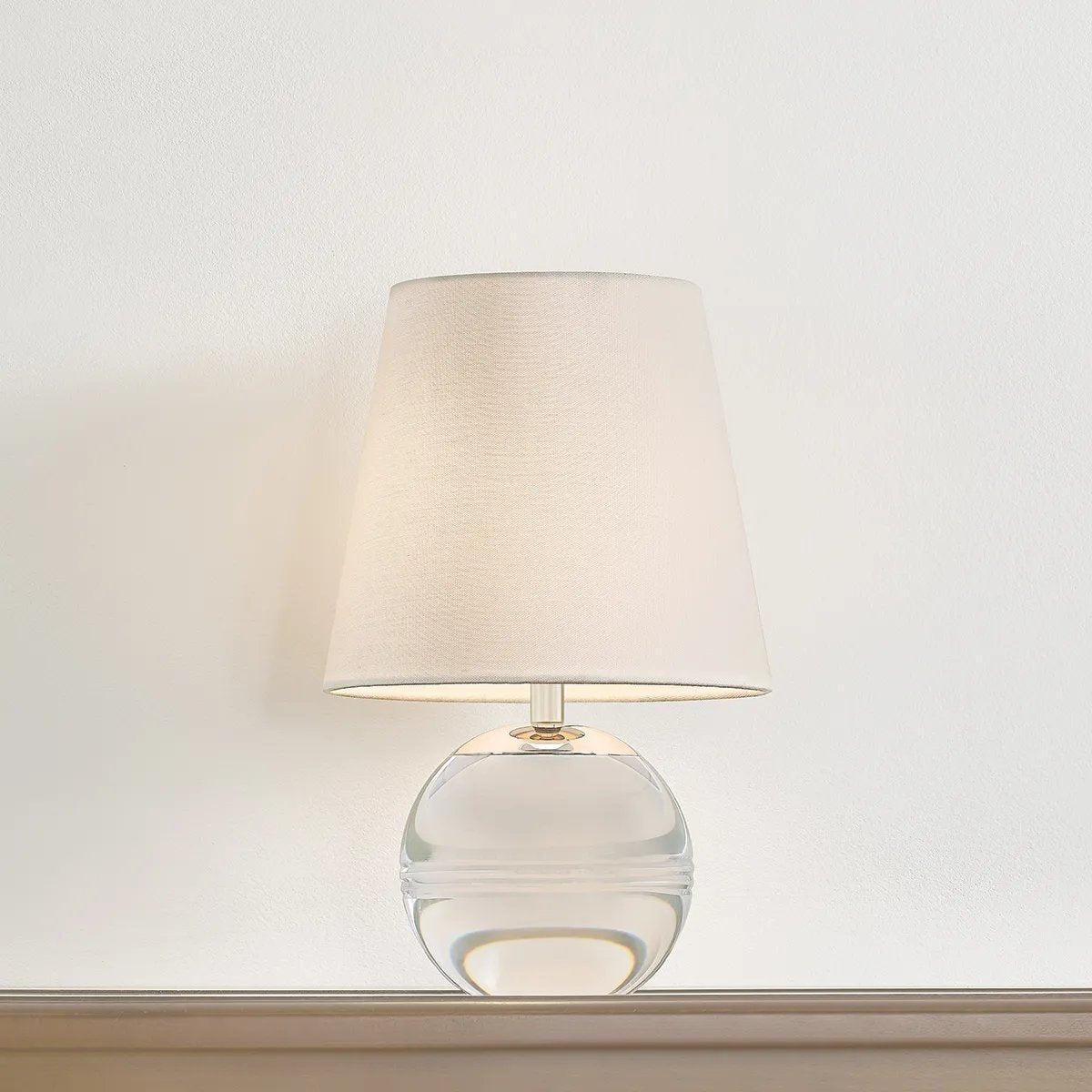 Ridged with ripple-like cuts, the crystal base of the Nicole table lamp makes for an eye-catching accent piece. Topped with a beautiful white linen shade, this pretty portable is rechargeable, adding convenience when styling. With classic Aged Brass-finished hardware, it’s the perfect addition to any bookshelf or small space. Amethyst Home provides interior design, new home construction design consulting, vintage area rugs, and lighting in the Omaha metro area.