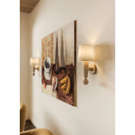 Inspired by the Scandinavian minimalist designs of Uno &amp; Östen Kristiansson, the Nola sconce’s gentle forms are constructed from natural neutrals. The base of the sconce has been handcarved from Cerused Whitewash Wood with its vertical grain and blond finish adding a dynamic texture to the piece. Amethyst Home provides interior design, new home construction design consulting, vintage area rugs, and lighting in the Nashville metro area.