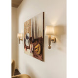 Inspired by the Scandinavian minimalist designs of Uno &amp; Östen Kristiansson, the Nola sconce’s gentle forms are constructed from natural neutrals. The base of the sconce has been handcarved from Cerused Whitewash Wood with its vertical grain and blond finish adding a dynamic texture to the piece. Amethyst Home provides interior design, new home construction design consulting, vintage area rugs, and lighting in the Nashville metro area.