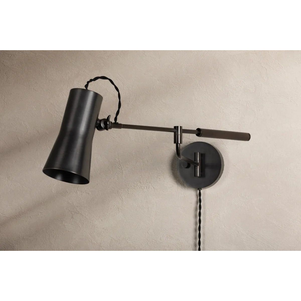 Tailored task lighting, this portable, functional swing arm sconce is also thoughtfully designed and beautiful. The sleek arm features a wooden handle on one end and an adjustable metal shade in Patina Brass or Bronze on the other. The twisted black cord detailing at the shade and backplate give Novel a nostalgic feel. Amethyst Home provides interior design, new home construction design consulting, vintage area rugs, and lighting in the Kansas City metro area.