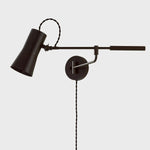 Tailored task lighting, this portable, functional swing arm sconce is also thoughtfully designed and beautiful. The sleek arm features a wooden handle on one end and an adjustable metal shade in Patina Brass or Bronze on the other. The twisted black cord detailing at the shade and backplate give Novel a nostalgic feel. Amethyst Home provides interior design, new home construction design consulting, vintage area rugs, and lighting in the Los Angeles metro area.