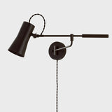 Tailored task lighting, this portable, functional swing arm sconce is also thoughtfully designed and beautiful. The sleek arm features a wooden handle on one end and an adjustable metal shade in Patina Brass or Bronze on the other. The twisted black cord detailing at the shade and backplate give Novel a nostalgic feel. Amethyst Home provides interior design, new home construction design consulting, vintage area rugs, and lighting in the Los Angeles metro area.
