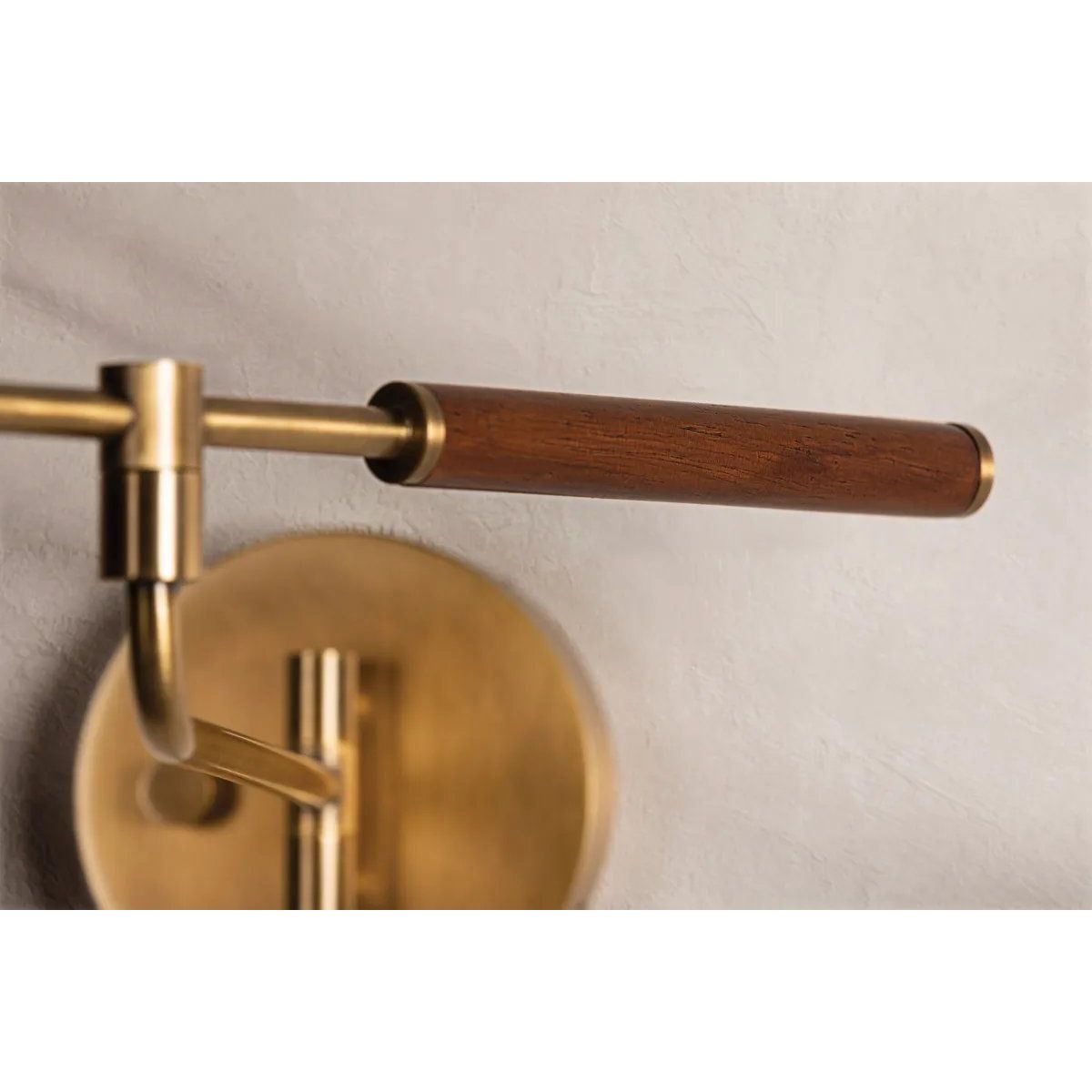 Tailored task lighting, this portable, functional swing arm sconce is also thoughtfully designed and beautiful. The sleek arm features a wooden handle on one end and an adjustable metal shade in Patina Brass or Bronze on the other. The twisted black cord detailing at the shade and backplate give Novel a nostalgic feel. Amethyst Home provides interior design, new home construction design consulting, vintage area rugs, and lighting in the Newport Beach metro area.