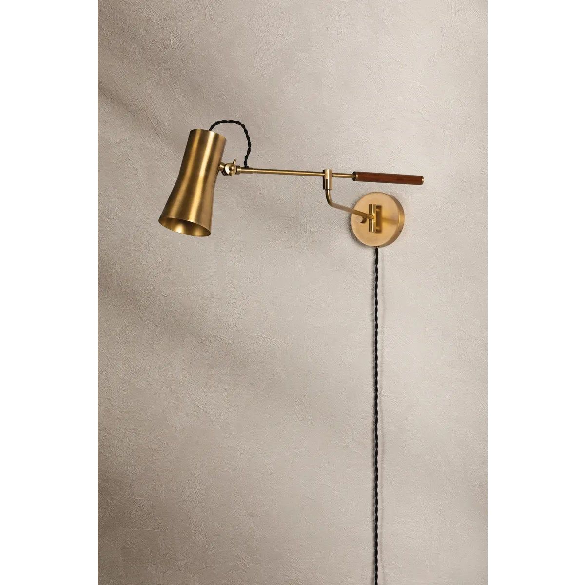 Tailored task lighting, this portable, functional swing arm sconce is also thoughtfully designed and beautiful. The sleek arm features a wooden handle on one end and an adjustable metal shade in Patina Brass or Bronze on the other. The twisted black cord detailing at the shade and backplate give Novel a nostalgic feel. Amethyst Home provides interior design, new home construction design consulting, vintage area rugs, and lighting in the Salt Lake City metro area.