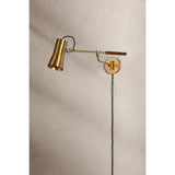 Tailored task lighting, this portable, functional swing arm sconce is also thoughtfully designed and beautiful. The sleek arm features a wooden handle on one end and an adjustable metal shade in Patina Brass or Bronze on the other. The twisted black cord detailing at the shade and backplate give Novel a nostalgic feel. Amethyst Home provides interior design, new home construction design consulting, vintage area rugs, and lighting in the Salt Lake City metro area.
