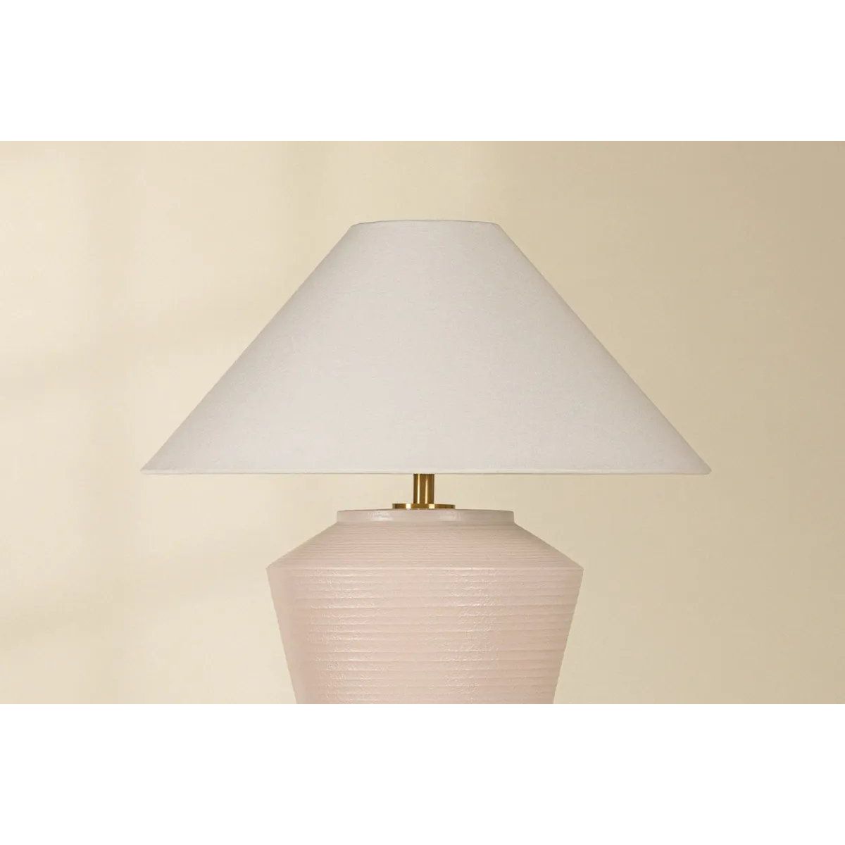 Inspired by raw beauty of the desert, this whitewashed terracotta table lamp is calm and refreshing. The textural body contrasts beautifully with the angular tapered white linen shade. An Aged Brass frame provides a surprising metallic finish. Part of THELIFESTYLEDCO® collection. Amethyst Home provides interior design, new home construction design consulting, vintage area rugs, and lighting in the Boston metro area.