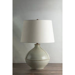 Inspired by rustic pottery, this table lamp's beautifully shaped base is crafted of pale sage ceramic giving it an earthy pale green tone. The off white linen shade pairs naturally and casts a soft glow. Raised seamlines and a reactive glaze that allows hints of the natural ceramic to peek through, give the fixture a hand-thrown, crafted feel. Amethyst Home provides interior design, new home construction design consulting, vintage area rugs, and lighting in the Seattle metro area.