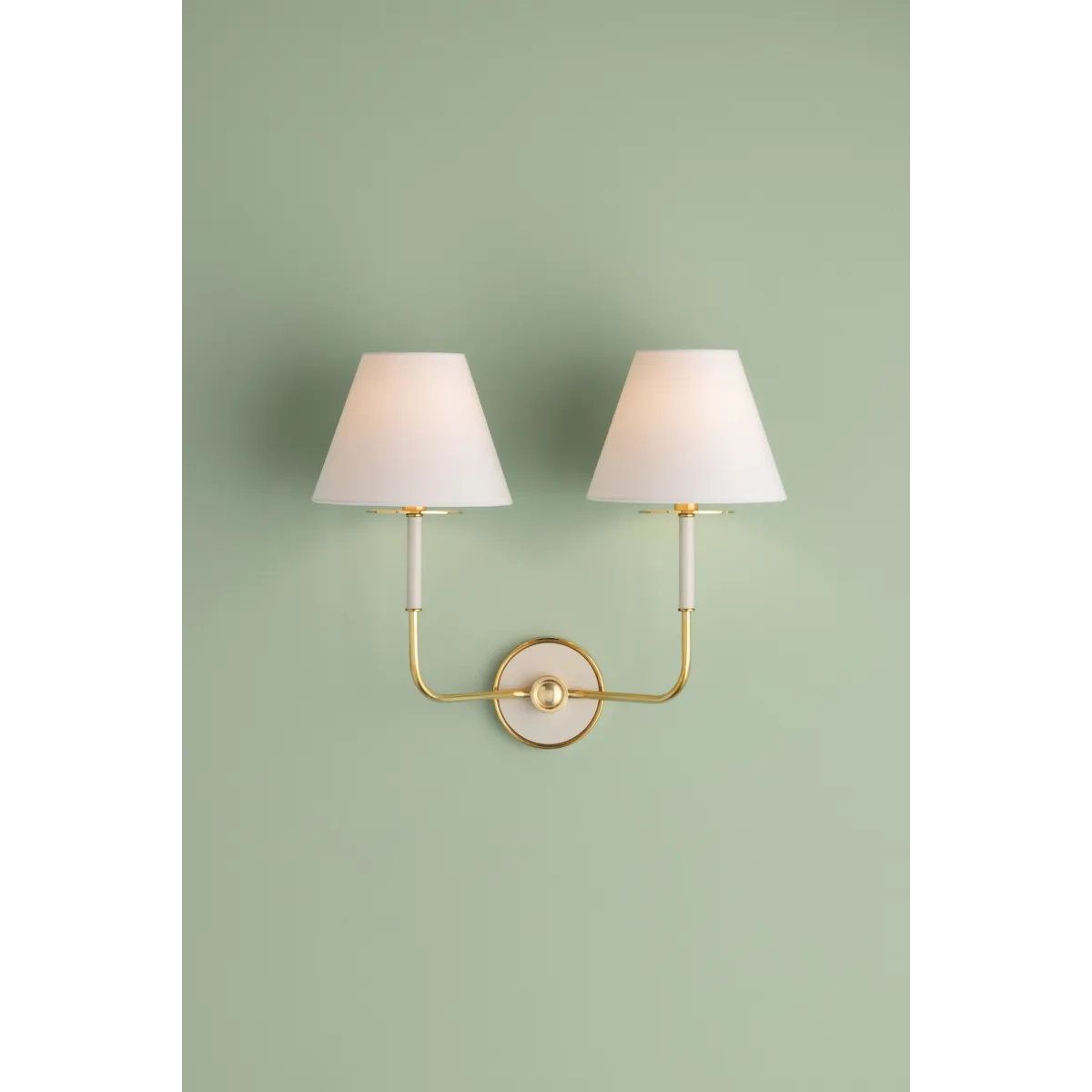 The refined framework and soft, tailored shades of Wedgewood evoke a sense of timeless, European charm. Available with one or two lights, this sconce features a classic shape, mixed finishes, and gently curved metalwork. Amethyst Home provides interior design, new home construction design consulting, vintage area rugs, and lighting in the Dallas metro area.