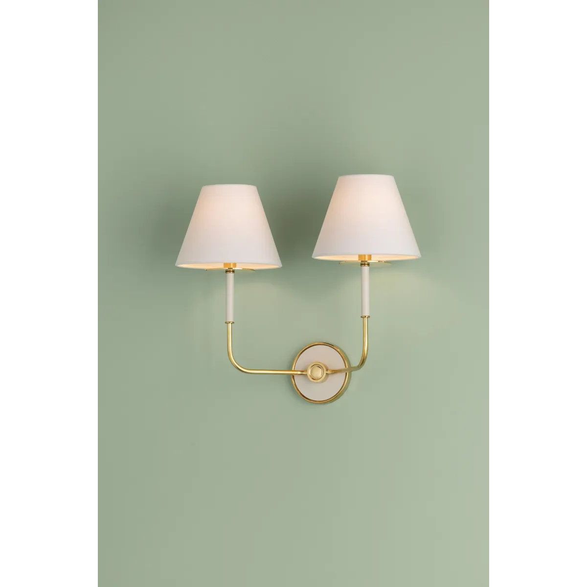 The refined framework and soft, tailored shades of Wedgewood evoke a sense of timeless, European charm. Available with one or two lights, this sconce features a classic shape, mixed finishes, and gently curved metalwork. Amethyst Home provides interior design, new home construction design consulting, vintage area rugs, and lighting in the Houston metro area.