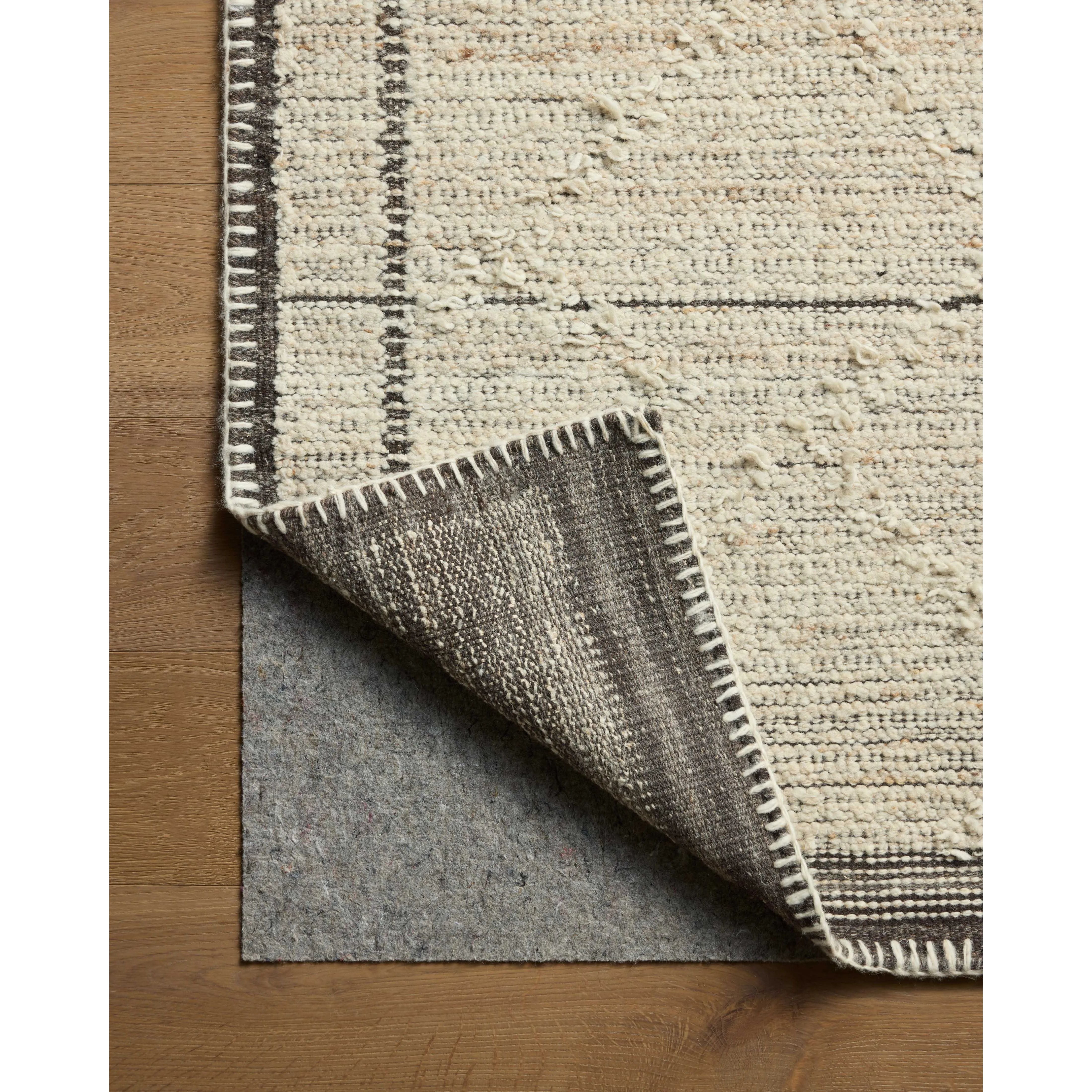Beautifully crafted by hand, the Bowie Collection by Amber Lewis x Loloi is a textured area rug with an earthy, organic aesthetic. The pile has a flatweave base with chunkier, slightly raised geometric motifs and whipstitched edges. It’s an elegant yet easy-to-work-with rug for living rooms, bedrooms, and other high-traffic areas of the home. Amethyst Home provides interior design, new home construction design consulting, vintage area rugs, and lighting in the Laguna Beach metro area.