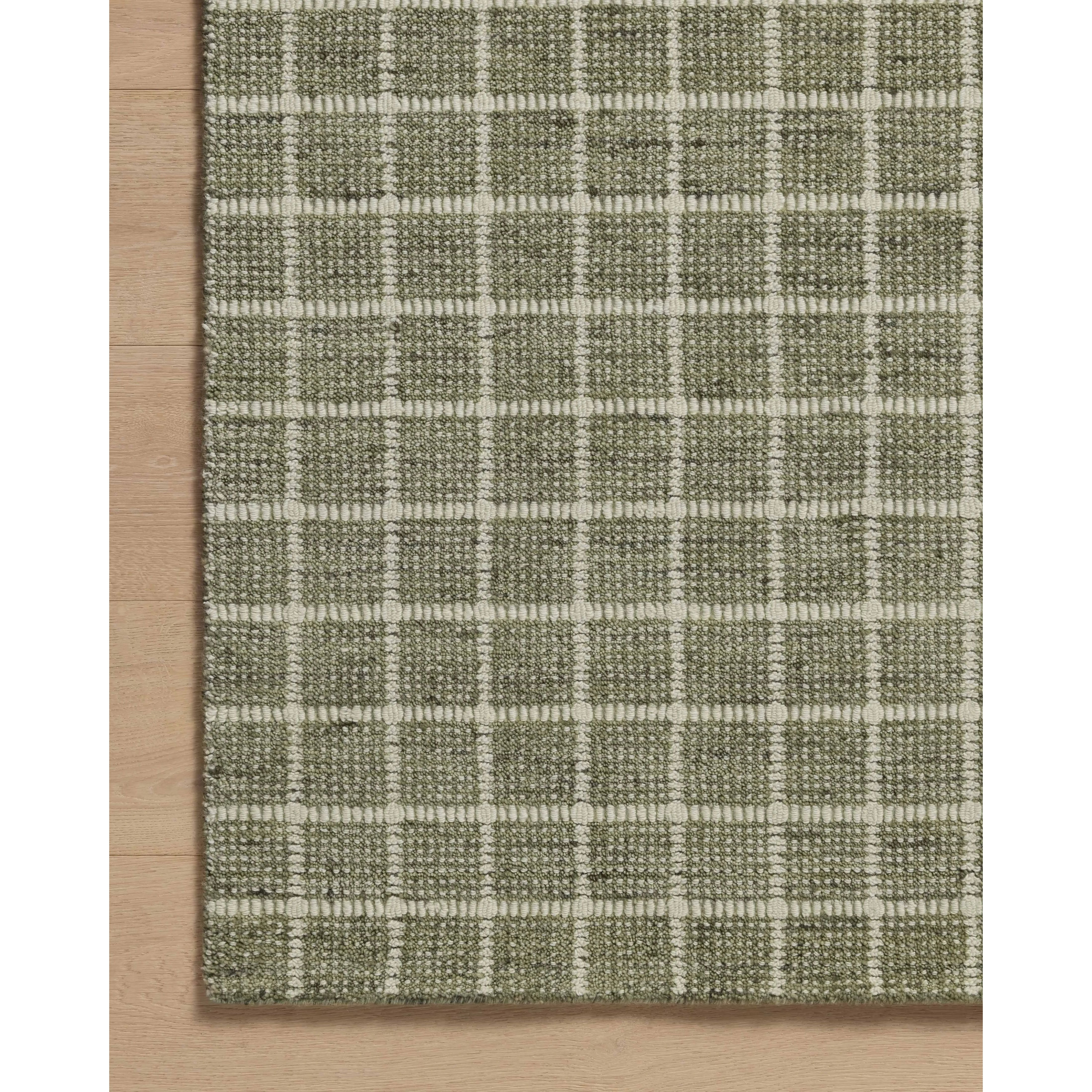 Featuring Amber Lewis x Loloi Cedar Olive / Ivory Rug by Loloi at Amethyst Home. The Cedar Collection by Amber Lewis x Loloi is a hand-loomed area rug with a clean gridded design in contrasting ivory. The rugs blended wool and cotton pile is substantial and soft, with flecked tones that add depth to the neutral palette. This collection is hand-loomed of woo. Amethyst Home provides interior design, new home construction design consulting, vintage area rugs, and lighting in the Charlotte metro area.