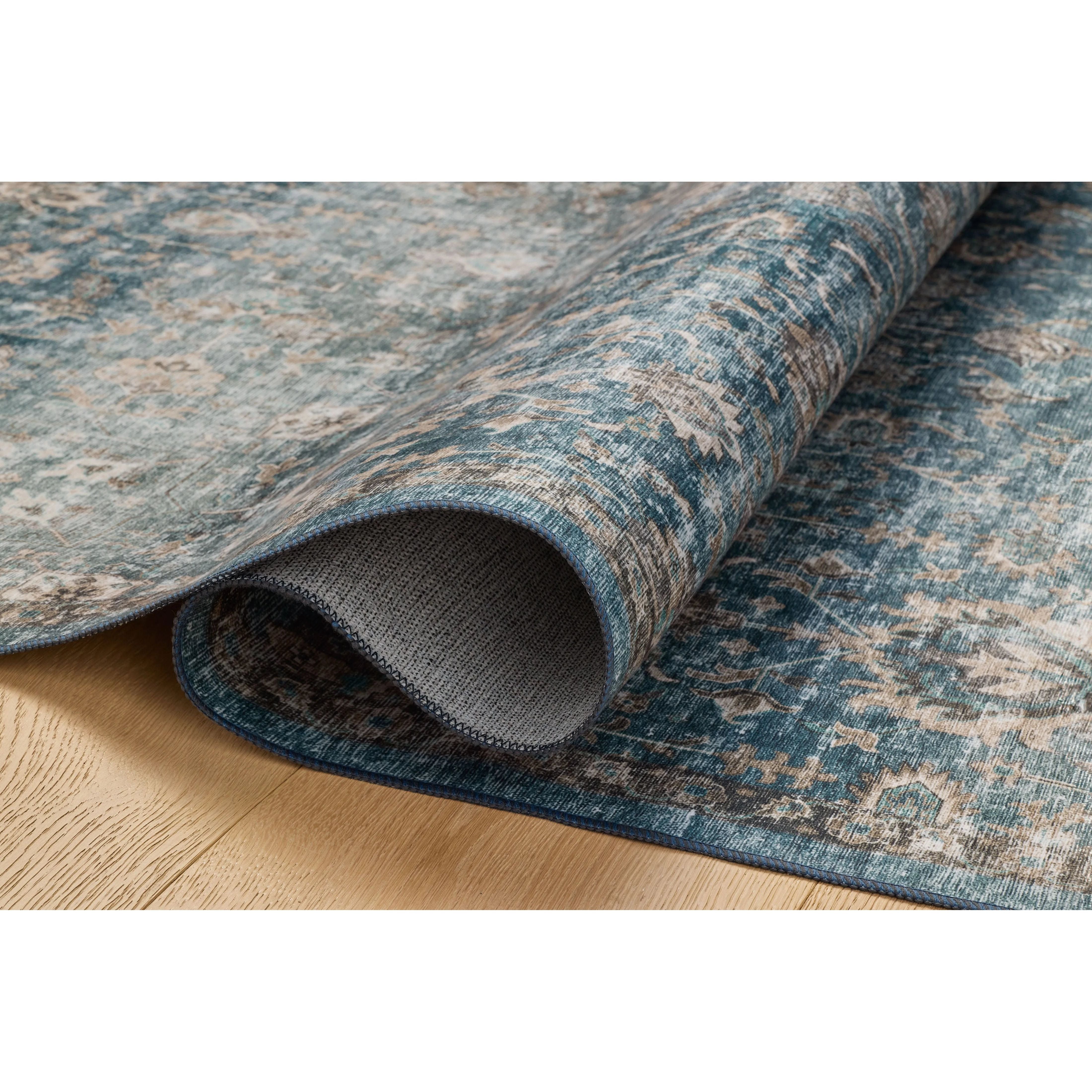 Featuring Anniston Machine Washable Lagoon / Natural Rug by Loloi at Amethyst Home. The Anniston Collection is a washable rug with traditional motifs in beautifully saturated and distressed tones. This durable area rug is power-loomed of polyester in China and designed for the busiest rooms of the home—living rooms, bedrooms, kitchens, hallways, and more. Amethyst Home provides interior design, new home construction design consulting, vintage area rugs, and lighting in the Laguna Beach metro area.