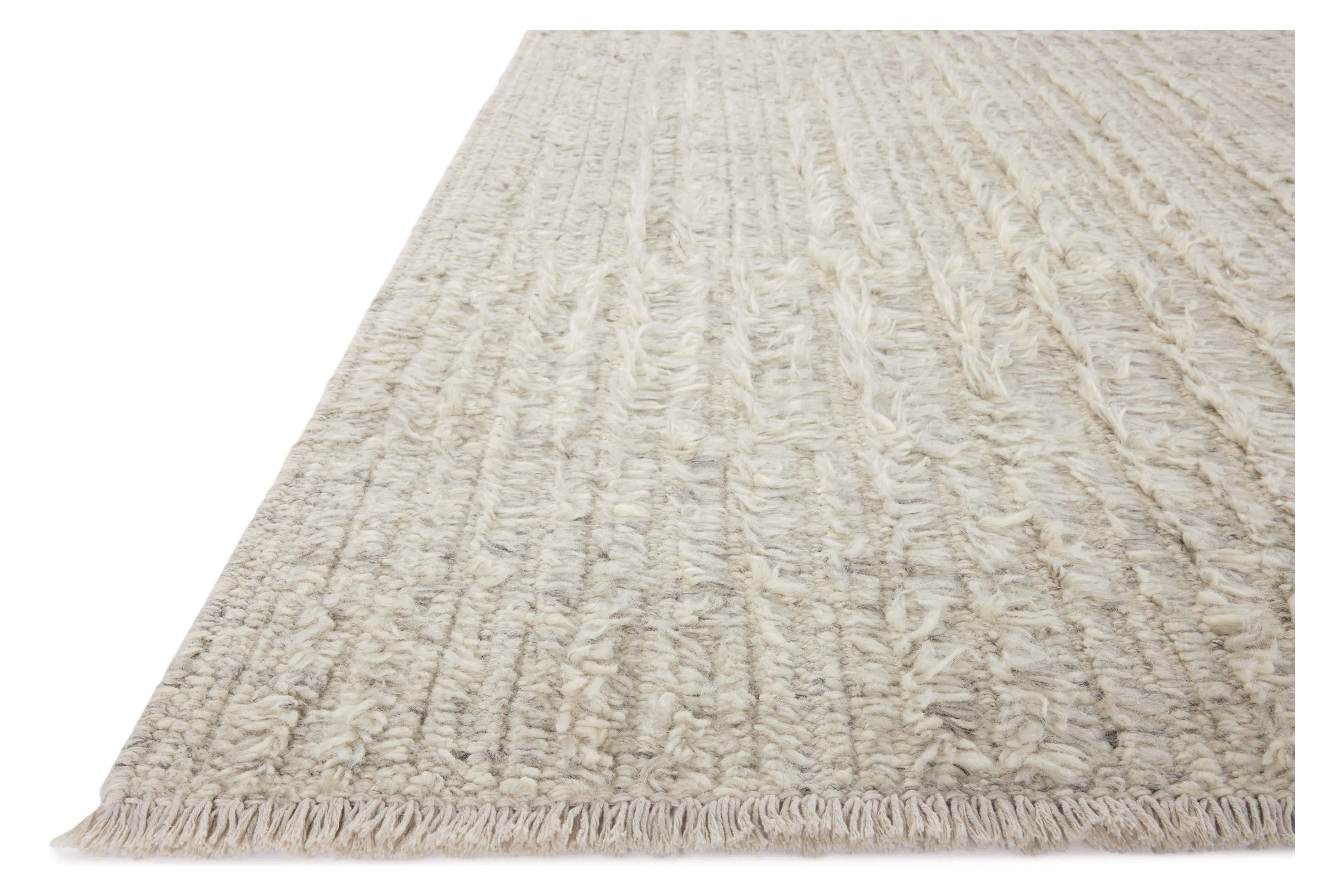 Irresistible to walk upon, the Dana Birch Rug by Brigette Romanek x Loloi has a high-low texture that alternates between a subtly shaggy pile and a soft base. Horizontal broken stripes give the area rug a fresh and energized structure, while a finish of fringe along the edges accentuates its sense of movement. Amethyst Home provides interior design, new home construction design consulting, vintage area rugs, and lighting in the San Diego metro area.