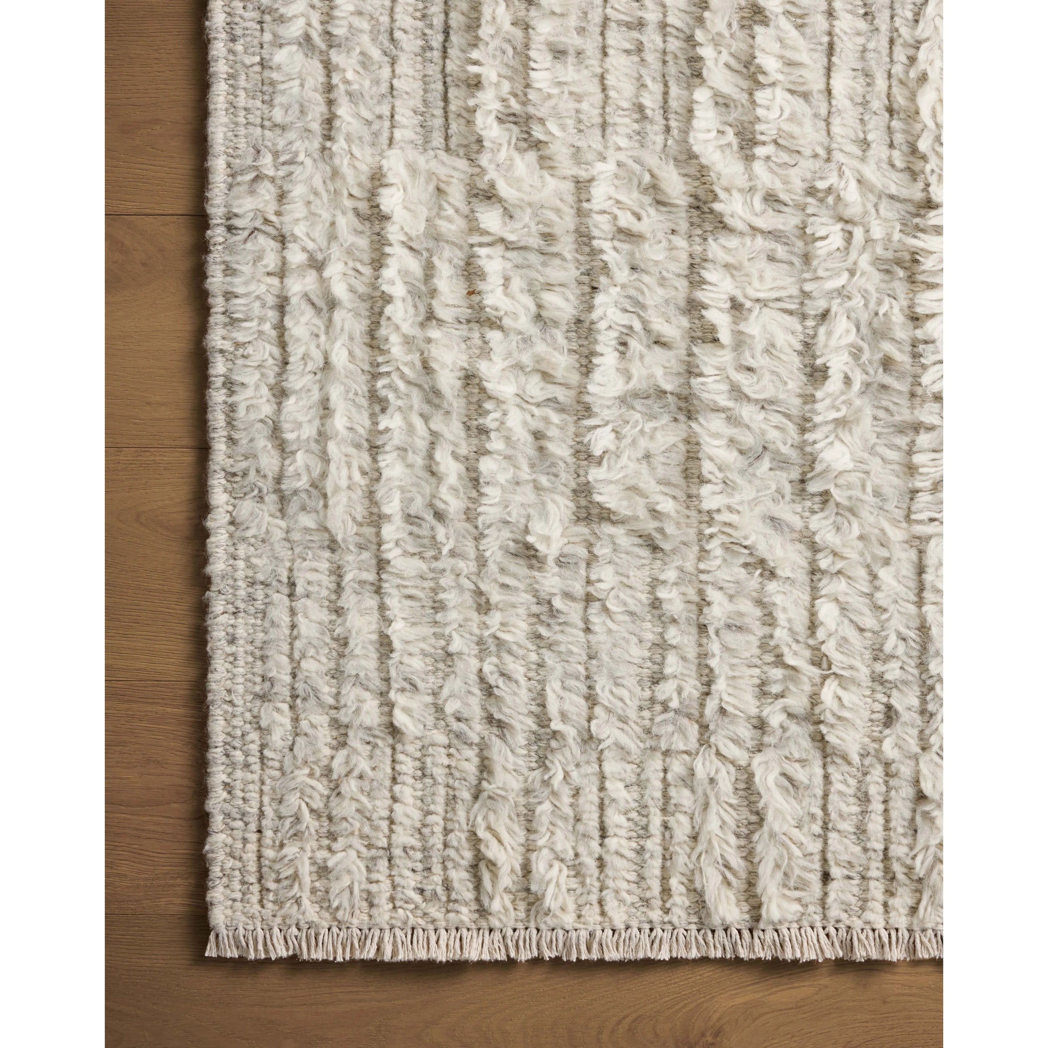 Irresistible to walk upon, the Dana Birch Rug by Brigette Romanek x Loloi has a high-low texture that alternates between a subtly shaggy pile and a soft base. Horizontal broken stripes give the area rug a fresh and energized structure, while a finish of fringe along the edges accentuates its sense of movement. Amethyst Home provides interior design, new home construction design consulting, vintage area rugs, and lighting in the Washington metro area.