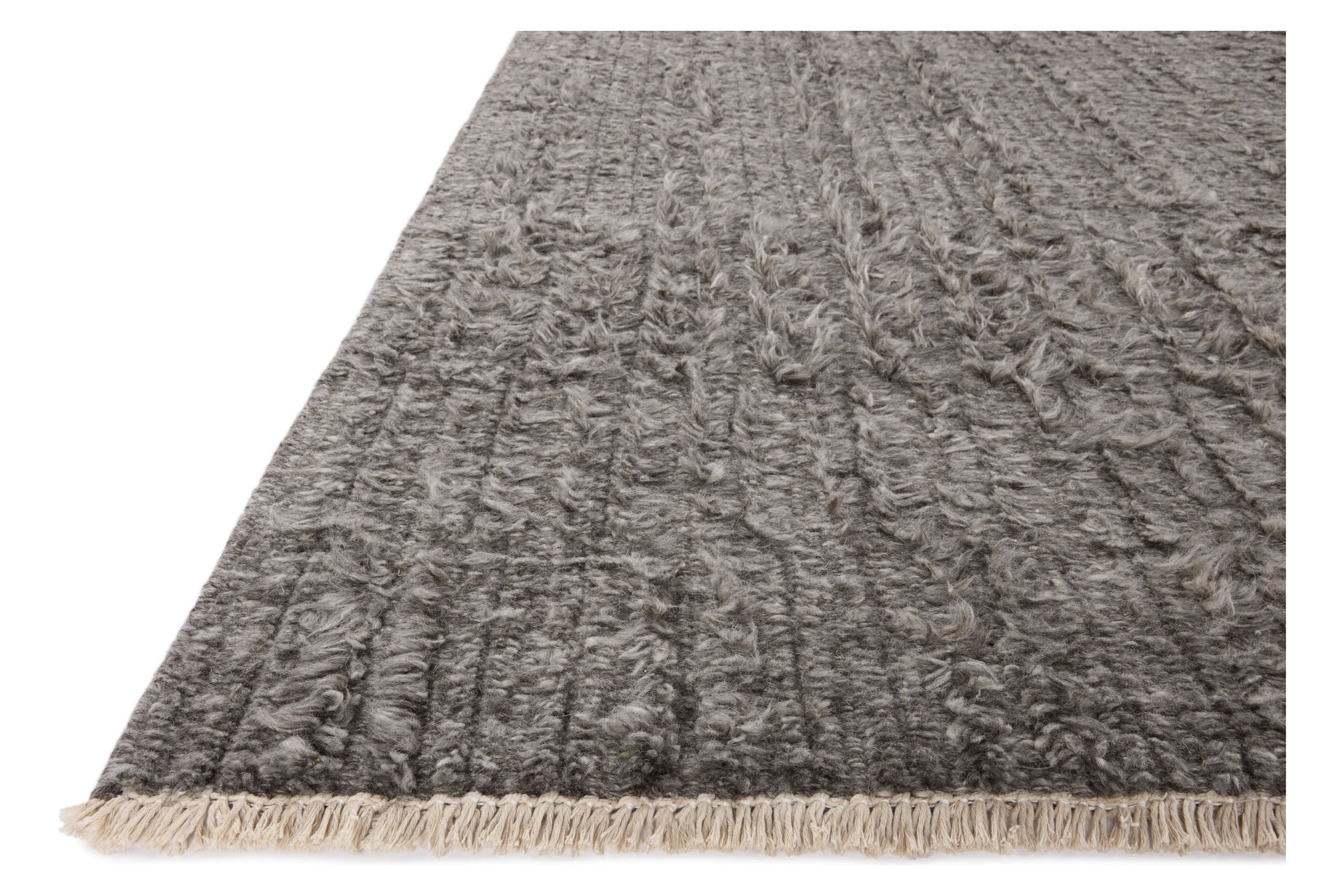 Irresistible to walk upon, the Dana Granite Rug by Brigette Romanek x Loloi has a high-low texture that alternates between a subtly shaggy pile and a soft base. Horizontal broken stripes give the area rug a fresh and energized structure, while a finish of fringe along the edges accentuates its sense of movement. Amethyst Home provides interior design, new home construction design consulting, vintage area rugs, and lighting in the Charlotte metro area.