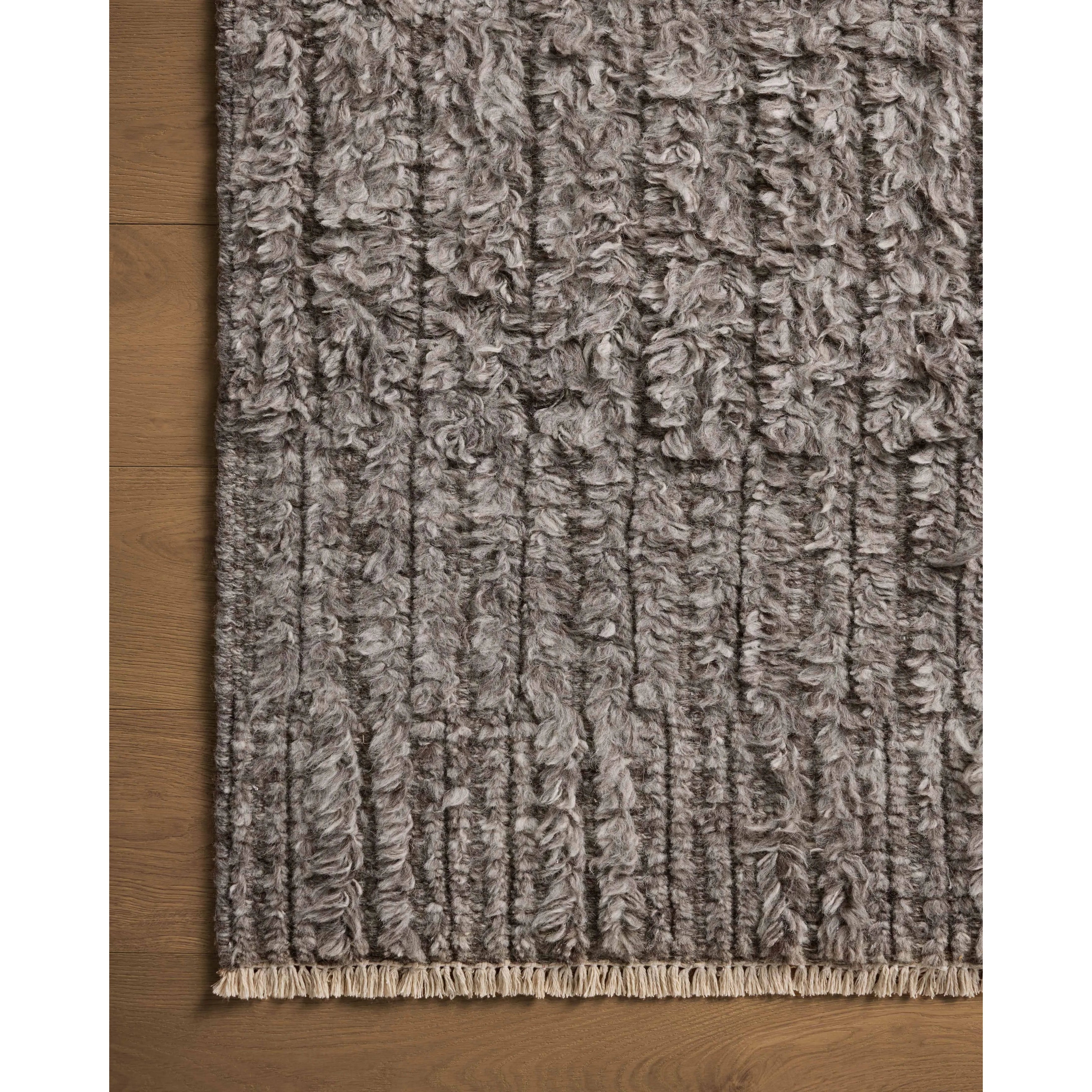 Irresistible to walk upon, the Dana Granite Rug by Brigette Romanek x Loloi has a high-low texture that alternates between a subtly shaggy pile and a soft base. Horizontal broken stripes give the area rug a fresh and energized structure, while a finish of fringe along the edges accentuates its sense of movement. Amethyst Home provides interior design, new home construction design consulting, vintage area rugs, and lighting in the Winter Garden metro area.
